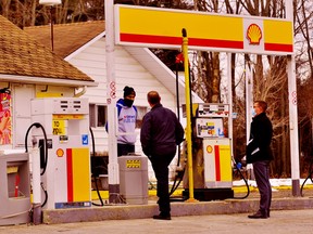 Bhav Moondi, an employee of St. Williams Gas & Variety, speaks to police officers investigating a drive-by shooting at the service station on Highway 24 north of St. Williams. The shooting occurred around 3:45 a.m. Sunday. There were no reports of injury. – Monte Sonnenberg