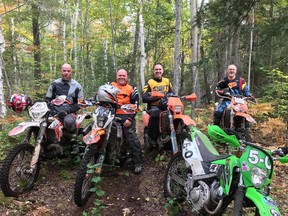 Members of the Sudbury Trail and Adventure Riders Association pause for a photo during a ride through the woods.