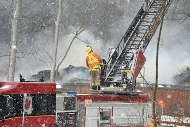 Firefighters operating a ladder truck parked in front of the Forest Motel try to get on top the flames to keep them from spreading further, however by this point fire officials said flames had spread throughout the building. Galen Simmons/The Beacon Herald/Postmedia Network