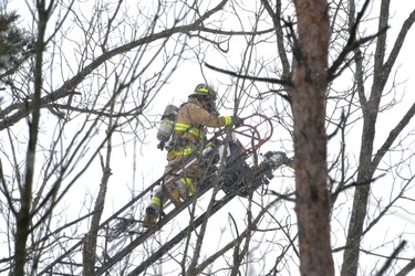 A Perth East firefighter is seen here spraying the fire from the top of a ladder truck. Galen Simmons/The Beacon Herald/Postmedia Network