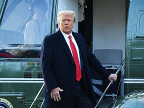 In this file photograph taken on Jan. 20, 2021, outgoing US President Donald Trump boards Marine One at the White House in Washington, DC. (MANDEL NGAN/AFP via Getty Images)
