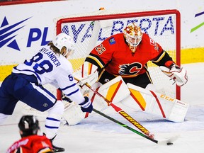 Jacob Markstrom of the Calgary Flames stops a shot from William Nylander (No. 88) of the Toronto Maple Leafs during an NHL game at Scotiabank Saddledome on Jan. 24 in Calgary. Photo by Derek Leung/Getty Images