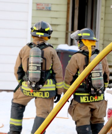 Firefighters respond to blaze at 61 and 65 Wellington St. E., on Saturday, Jan. 30, 2021 in Sault Ste. Marie, Ont. Firefighters stand near scene warning of falling ice. (BRIAN KELLY/THE SAULT STAR/POSTMEDIA NETWORK)