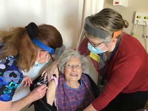 Resident Joan Robinson receives her first dose of the Moderna vaccine with Anne Scott administrating it and Cathy Lane assisting. SUBMITTED