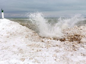 Waves splash against the mounds of ice near the pier in Grand Bend on Jan. 26. Dramatically reduced ice cover on the Great Lakes this winter is a concern, not just for ice fishers and skaters. Mike Hensen/Postmedia Network