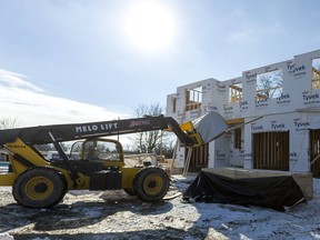 Aaron Letkeman moves a bundle of two-by-fours for a housing project in Mt. Brydges by Banman Homes on Jan. 21. The project has 70 units in total. The first phase of 21 units is sold at a price of $450,000 each. General manager Paul Banman says he gets two groups of buyers, "first-time homebuyers and retirement age." Middlesex county is projected to have a lot of growth, including an ageing population that will need more services in their communities, a report to council said. Mike Hensen/Postmedia Network