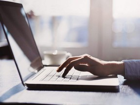 Human hand on laptop keyboard