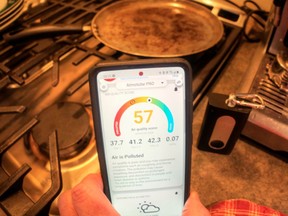 The Atmotube unit, with instant phone readout showing poor air quality after cooking griddle cakes on the stove.