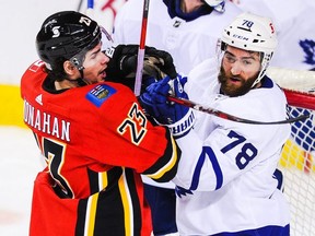 Sean Monahan (23) of the Calgary Flames checks T.J. Brodie (78) of the Toronto Maple Leafs during an NHL game at Scotiabank Saddledome on January 24, 2021, in Calgary, Alberta, Canada. (Photo by Derek Leung/Getty Images)