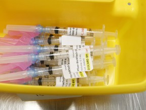 Health-care technicians prepare syringes of the Pfizer-BioNTech COVID-19 vaccine for front-line health-care workers at a UHN clinic at the MaRS building in Toronto on Jan. 7. Jack Boland/Toronto Sun