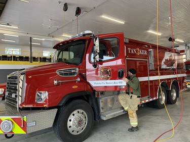 Volunteer firefighter Jody Catalan gets into the new tanker prior to heading out for a recent service call at the West Perth fire station. ANDY BADER
