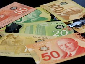 Photos displaying the new versions of the Canadian $20, $50 and $100 polymer notes are shown in Calgary, May 2, 2012.