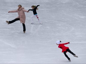 People skate at Toronto's Nathan Phillips Square on the first day of the a stay-at-home order on Thursday Jan. 14, 2021