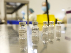 UHN (University Health Network) technicians prepare syringes of the Pfizer-BioNTech COVID-19 vaccine for front-line health-care workers at a UHN clinic at the MaRS building on January 7, 2021.