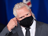 Ontario Premier Doug Ford takes his mask off to answer questions from the media at Queen's Park.