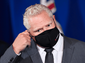 Ontario Premier Doug Ford takes his mask off to answer questions from the media at Queen's Park during the COVID-19 pandemic in Toronto on Sept. 28.