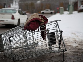 A jacket rests on an overturned shopping cart on the corner of Queen Street and Fraser Avenue in Fort McMurray's downtown, in this October 2016 file photo. Olivia Condon/ Fort McMurray Today/ Postmedia Network