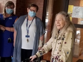 Maple View resident Eleonore Kueber, the first Grey County resident to receive a COVID-19 vaccine, smiles as long-term care staff Alison McEachnie, far left, and executive director Tracee Givens smile too Friday, Jan. 15, 2021 in Owen Sound, Ont. (Scott Dunn/The Sun Times/Postmedia Network)