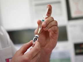 A medical worker draws the Pfizer-BioNTech COVID-19 vaccine from a vial at the Max Fourastier hospital in Nanterre, as the spread of the coronavirus disease continues in France, January 5, 2021.