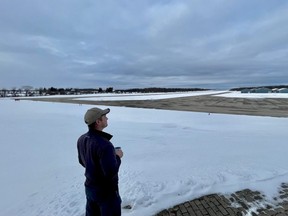 Owen Sound Flight Services owner Dave Kalistchuk, who launched a petition opposing landing fees at Owen Sound's regional airport, looks out over the facility's runway. SUPPLIED