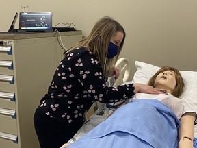 Keyano College nursing students take part in a virtual simulation by guiding their instructor on how to care for the mock patient. Supplied image/Keyano College