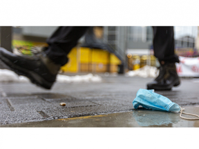 A discarded medical mask sits rumpled along Dundas Street in downtown London. (Mike Hensen/The London Free Press)