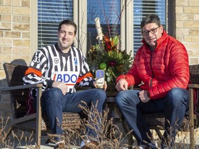 World Junior Hockey Championship referee Carter Sandlak (left) sits with his proud father Jim Sandlak in London. (Derek Ruttan/The London Free Press)