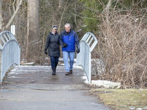 Cathie Gauthier and her husband Bob walk through the woods in London's Hastings Park in London on Thursday January 21, 2021. (Derek Ruttan/The London Free Press)