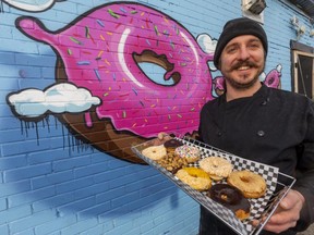 Andy Paquet, owner of V Food Spot, shows off a selection of his vegan doughnuts at his cafe on Hamilton Road at Rectory Street. (Mike Hensen/The London Free Press)