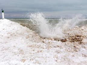 Waves splash against the mounds of ice near the pier in Grand Bend on Tuesday, Jan. 26, 2021. Dramatically reduced ice cover on the Great Lakes this winter is a concern, not just for ice fishers and skaters. (Mike Hensen/The London Free Press)