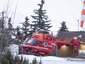 The STARS helicopter sits on the landing pad in front of the Queen Elizabeth II Hospital Tuesday morning where it sat overnight Monday. 
RANDY VANDERVEEN