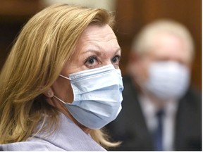 Ontario Health Minister Christine Elliott listens as Ontario Premier Doug Ford gives an update regarding the Ontario COVID-19 vaccine during the COVID-19 pandemic in Toronto on January 5, 2021. PHOTO BY NATHAN DENETTE /THE CANADIAN PRESS