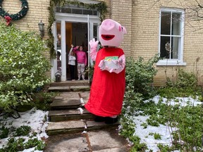 Peppa Pig – one of many storybook characters that will be involved in the Feb. 6 Storybook Breakfast Picnic – shows off a sample book, activity and snack box at the home of Ellie and Lylah Moffat.