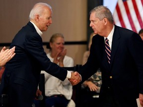 Democratic 2020 U.S. presidential candidate and former Vice President Joe Biden shakes hands with former Iowa Governor Tom Vilsack during a campaign event in Newton, Iowa, U.S., January 30, 2020. (REUTERS/Mike Segar/File Photo)