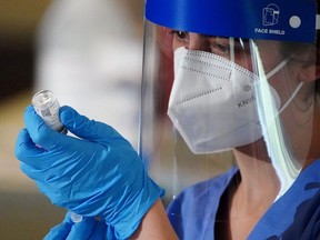 A nurse prepares a syringe with the COVID-19 Moderna vaccine.