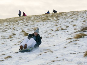 At East Lake Park, families enjoyed sledding down the hill over the weekend. Many have been taking to outdoor activities with enhanced COVID-19 restrictions in place. Photo by Kelsey Yates