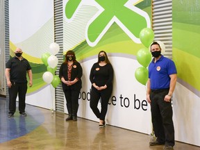 From left to right, Home Depot store manager Tony Hill, BGCA staff members Kathy Ritcher and Sam Morros, and assistant store manager Brandon Memanishen pose in front of the new mural at the Boys and Girls Club of Airdrie in January of 2020. Photo by Kelsey Yates