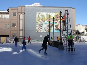 The first skaters take to the ice on Bear Street's new rink on Jan. 8. while maintenance staff finish errecting lights. The small skating rink can accommodate 20 skaters at a time under current COVID-19 restrictions. Photo Marie Conboy/ Postmedia.