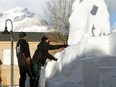 The streets of downtown Banff transform into a winter gallery for the SnowDays Snow Sculptures this month, running Jan.20-31. (Pictured) Snow sculptors, David Ducharme, originally from Quebec, and Susanne Ruseler, from the Netherlands, work on their piece Drifting Broncos on Banff Avenue on Sunday, Jan. 17. Using a blend of power and handcrafted tools to shape the translucent ice blocks. Photo Marie Conboy/ Postmedia.