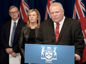 Ontario Premier Doug Ford speaks to reporters as Health Minister Christine Elliott and Dr. David Williams listen. POSTMEDIA PHOTO