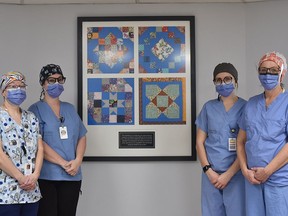 From left, Dawn MacDonald Ð Registered Pharmacy Technician, Jennifer Woods Ð Registered Nurse, Courtney Penfold Ð Registered Practical Nurse and Ann Chamberlain Ð Environmental Service Worker, stand in front of the framed Quilt Blocks while wearing their donated scrub camps. The Quilt Blocks which is made up of fabric from masks, gowns and caps was donated by the Campbellford Mask Makers. CAITLIN LAVOIE