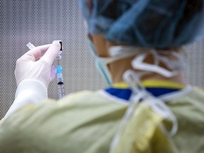 A pharmacy worker prepares a dose of the Pfizer-BioNTech COVID-19 vaccine.