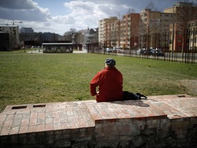 A woman sits at the Berlin Wall Memorial in Bernauer Srasse, a tourist hotspot of the German capital.