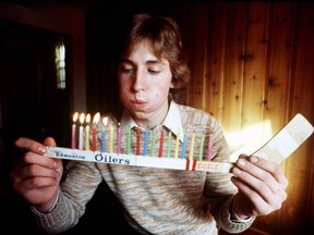 Wayne Gretzky blows out candles to celebrate his 18th birthday while a member of the Edmonton Oilers of the World Hockey Association. Gretzky turned 60 on Tuesday.