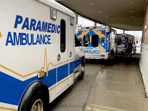 A paramedic walks toward the Brockville General Hospital emergency entrance as three ambulances are lined up. (FILE PHOTO)