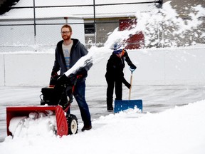 A decent snowfall and dropping temperatures meant Saturday was a good day to clear the Merrickville outdoor rink for a new flooding.  Collin Aitken, a volunteer firefighter, drives the snowblower while  Carter Seeley scrapes the surface clear with shovels. Aitken is now the volunteer point person who will maintain the rink for the rest of the season. (HEDDY SOROUR/Local Journalism Initiative)