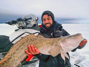 Joey Teofilo, of King City, Ont., holds up a massive burbot while ice fishing on Lake Nipissing Jan. 4. Facebook Photo