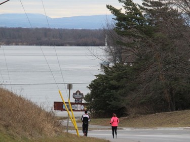 Runners on Boundary Road, heading toward the St. Lawrence River, and with the Adirondack Mountains in the distance. Photo on Friday, January 1, 2020, in Cornwall, Ont. Todd Hambleton/Cornwall Standard-Freeholder/Postmedia Network