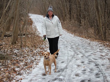 Julie Fontaine and Marney, a miniature lab, enjoying an afternoon walk on a fairly icy trail at the Gray's Creek Conservation Area. Photo on Friday, January 1, 2020, in Cornwall, Ont. Todd Hambleton/Cornwall Standard-Freeholder/Postmedia Network