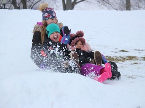 Acadiah Huygen (13, left), with her brother Hudsyn (nine) and sister Dehlta (four) make their way down the slope in Lamoureux Park on Monday afternoon. Photo on Monday, January 4, 2020, in Cornwall, Ont. Todd Hambleton/Cornwall Standard-Freeholder/Postmedia Network